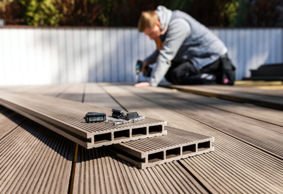 Decking in Abingdon-a man performing some work on a decking strips.