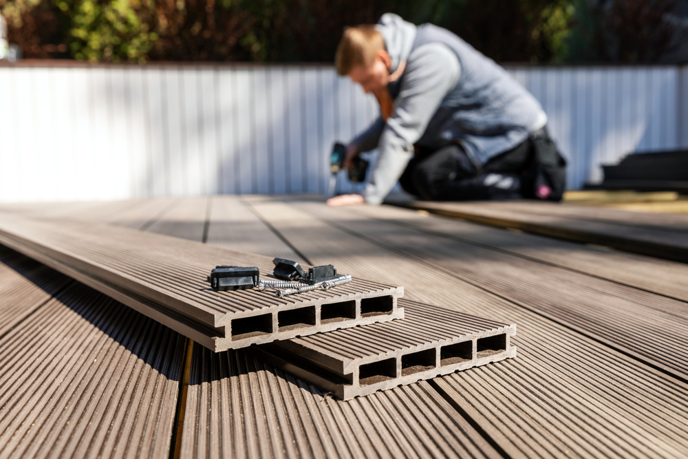 Decking in Abingdon-a man performing some work on a decking strips.