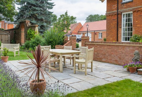 An elegant patio in Radley, 5 light brown chairs positioned around a table