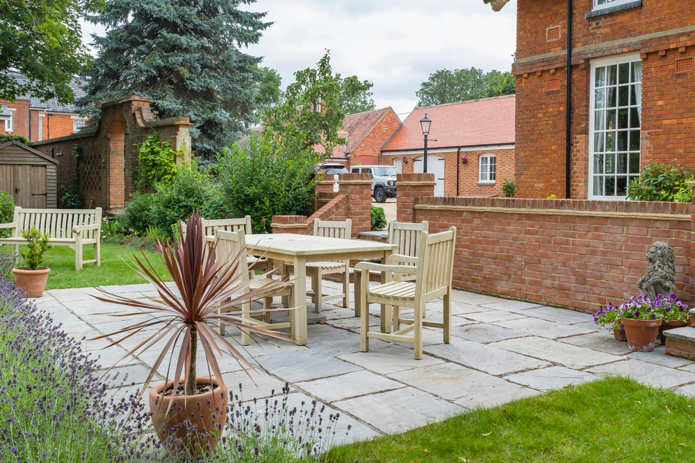 An elegant patio in Radley, 5 light brown chairs positioned around a table